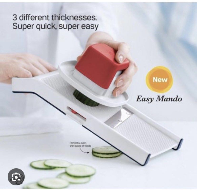 Tupperware Easy Mando Food Slicer Cutter (Category: Knives & Chopping Boards) located in Cavite. Submitted by yc.shoppemnl (Listing ID 1470069363, Image 1). Description: - Authentic Tupperware Easy Mando slicer - Color: White and dark blue frame with a bright red finger guard pusher - 3 adjustable thickness settings via a side switch - Ultra-sharp stainless steel blade for effortless slicing - Textured surface prevents food from sticking - Perfec