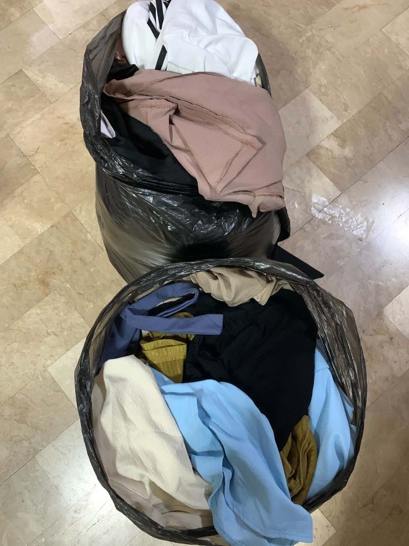 Two bags of assorted preloved clothing bundle (Category: Activewear) located in Cavite. Submitted by serkennnnnn (Listing ID 1470071007, Image 1). Description: - Closet cleanout bundle: 2 large trash bags of preloved clothes - Variety of items: Includes tops and bottoms - Color palette: Blue, black, white, and beige - Style: Great mix of casual everyday wear - Condition: Preloved - Selling term: Bundle pack only (take everything in one go) -Used 