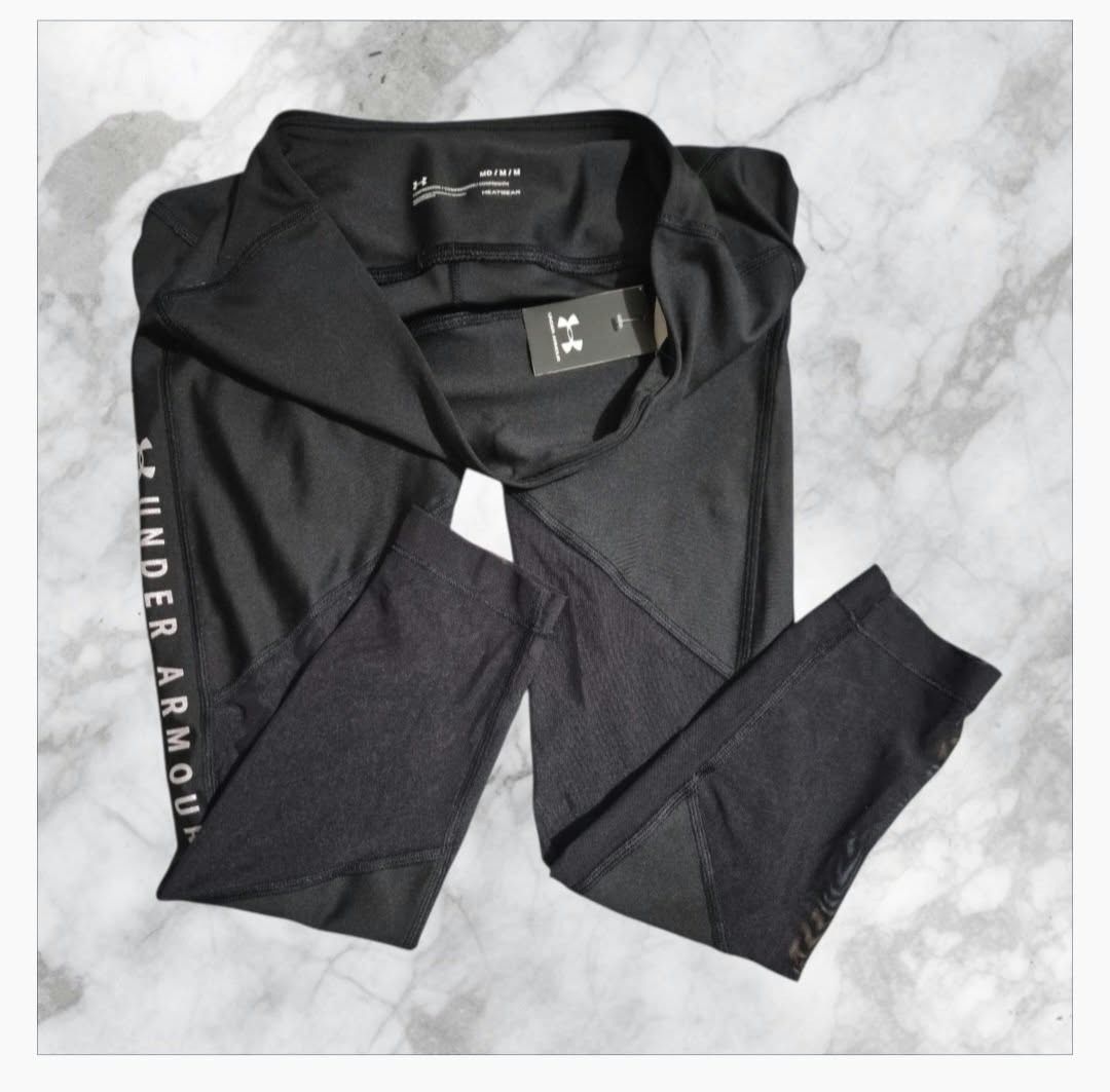 Under Armour Black Mesh Leggings Crop (Category: Activewear) located in Paranaque City. Submitted by calm_youngstore7 (Listing ID 1469967456, Image 3). Description: LOWEST PRICE GUARANTEED! Under Armour HeatGear leggings in black. Size M. High-waisted style with mesh panels down the lower legs for extra breathability. Brand logo printed vertically along the left leg in white. Original tags still attached, never worn. Great for workouts, running, 