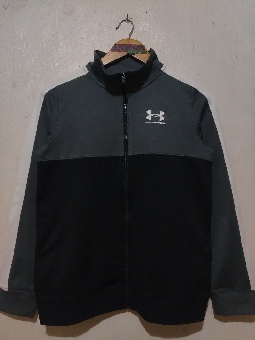 Under Armour Full-Zip Track Jacket (Category: Coats, Jackets and Outerwear) located in Rizal. Submitted by gmpastoffi75031 (Listing ID 1470012021, Image 1). Description: - Brand: Under Armour - dimes 18.5x25 - Color: Grey and black with white contrast sleeve stripes - Size: Youth Extra Large (Loose fit) - Design: Full zip front closure with a high collar - Material: 100% polyester body, 91% polyester rib - Care: Wash instructions printed on insid