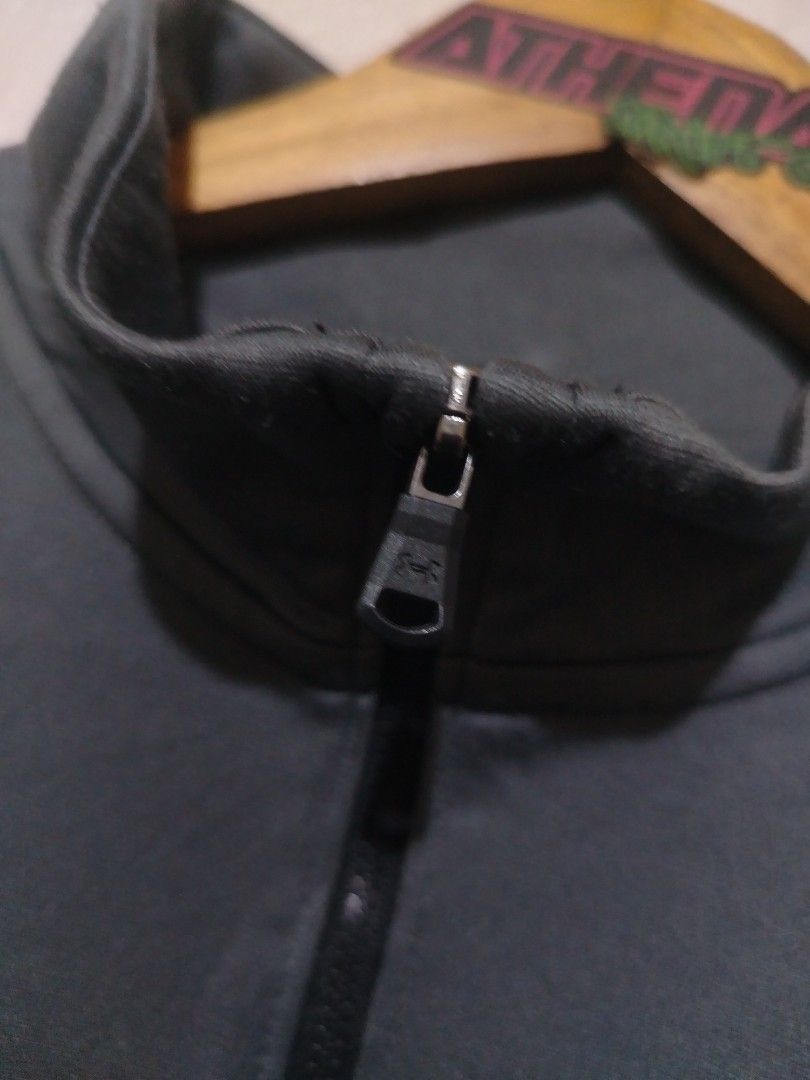 Under Armour Full-Zip Track Jacket (Category: Coats, Jackets and Outerwear) located in Rizal. Submitted by gmpastoffi75031 (Listing ID 1470012021, Image 3). Description: - Brand: Under Armour - dimes 18.5x25 - Color: Grey and black with white contrast sleeve stripes - Size: Youth Extra Large (Loose fit) - Design: Full zip front closure with a high collar - Material: 100% polyester body, 91% polyester rib - Care: Wash instructions printed on insid