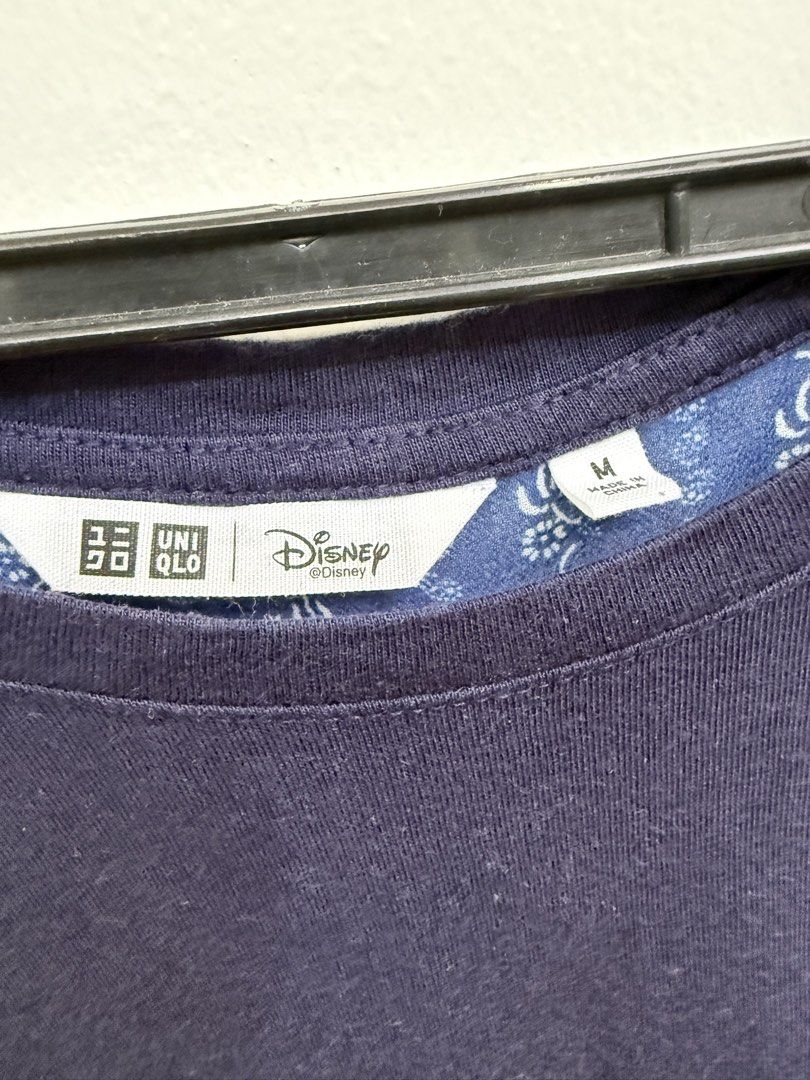 Uniqlo Disney Navy Blue Patterned Top Size M (Category: Shirts) located in Quezon City. Submitted by reivia.vend (Listing ID 1469989660, Image 2). Description: - Brand: Uniqlo (Disney Collection) - Color: Navy Blue with patterned back - Size: Medium (M) - Design: Short sleeves, round neckline, solid front, and patterned fabric on back and shoulders - Condition: Clean, excellent, and ready to wear.