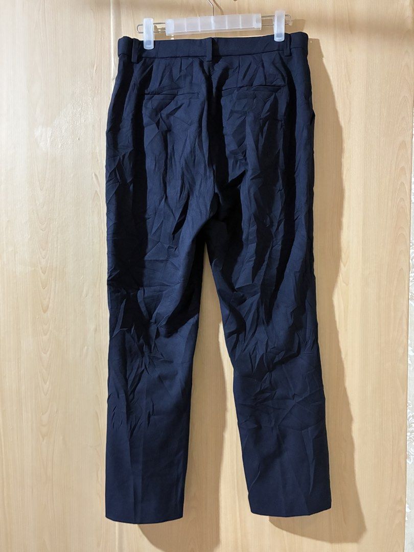 Uniqlo Navy Trousers Size L (Category: Trousers) located in Placer. Submitted by talaalond61563 (Listing ID 1470048204, Image 2). Description: - Brand: Uniqlo - Color: Navy - Size: L - Material: 65% Polyester, 31% Rayon, 4% Polyurethane (with comfortable stretch) - Waist Fit: 69 to 75 cm - Hip Fit: 94 to 100 cm - Fit: Straight leg - Features: Belt loops, standard pockets - Origin: Made in China - Condition: Great for office and casual wear!.