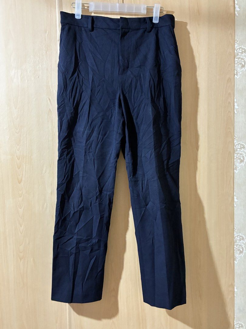 Uniqlo Navy Trousers Size L (Category: Trousers) located in Placer. Submitted by talaalond61563 (Listing ID 1470048204, Image 1). Description: - Brand: Uniqlo - Color: Navy - Size: L - Material: 65% Polyester, 31% Rayon, 4% Polyurethane (with comfortable stretch) - Waist Fit: 69 to 75 cm - Hip Fit: 94 to 100 cm - Fit: Straight leg - Features: Belt loops, standard pockets - Origin: Made in China - Condition: Great for office and casual wear!.