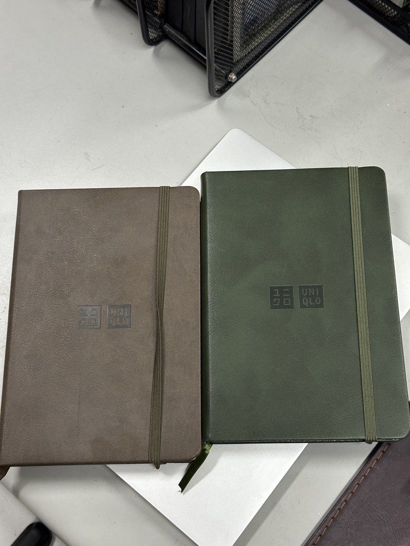 Uniqlo Notebook Set (Category: Stationery & School Supplies) located in Quezon City. Submitted by bqchane (Listing ID 1470055652, Image 1). Description: - Set of 2 Uniqlo notebooks (Brown and Green) - Premium smooth faux leather hardcover with debossed logo - Secure elastic band closure - Built-in ribbon bookmark - Ideal for daily journaling, school, or office note-taking.