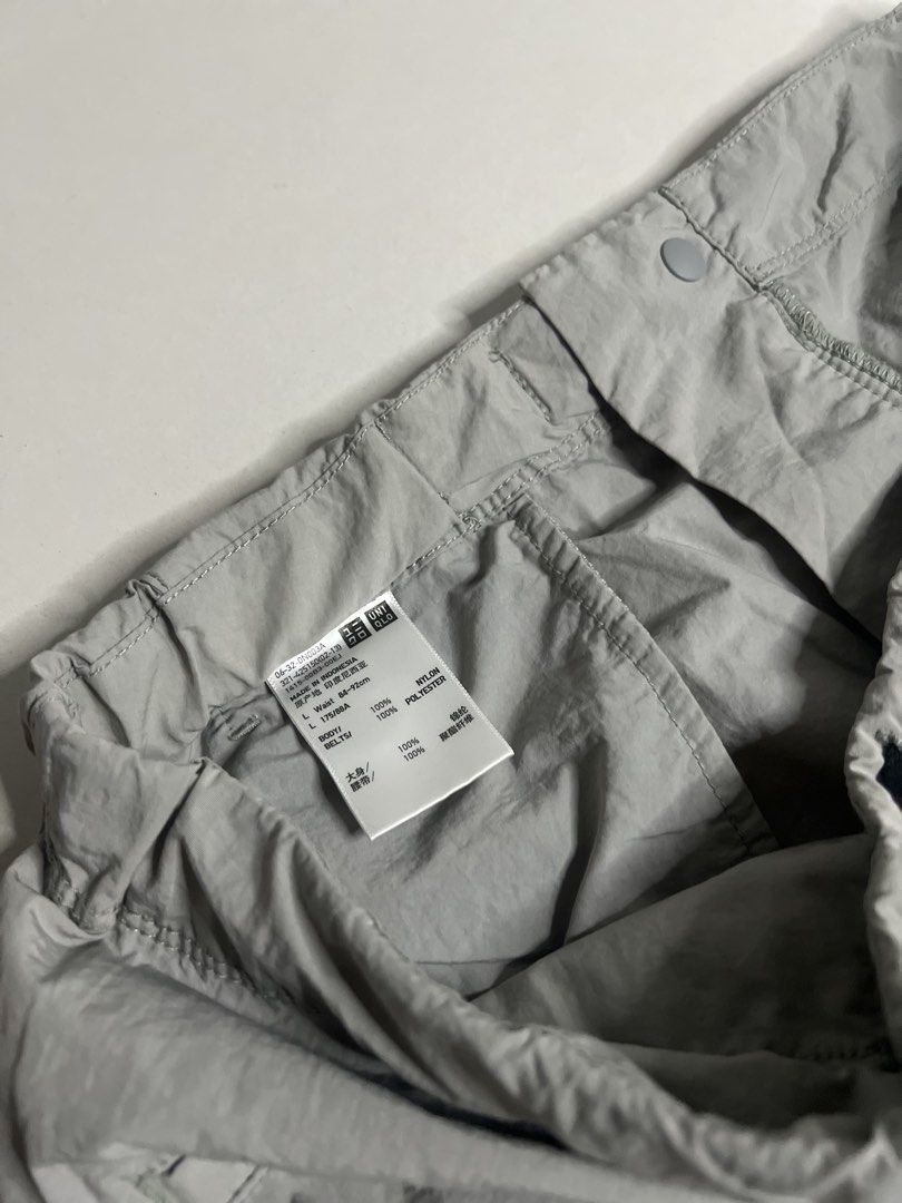 Uniqlo Utility ShortsGrey Size L (Category: Shorts) located in Tacloban City. Submitted by thrftg (Listing ID 1470086647, Image 2). Description: - Brand: Uniqlo - Color: Grey - Size: L (fits waist 84-92cm) - Material: Nylon and polyester blend - Features: Built-in adjustable belt with buckle, elastic waistband, and zipper fly - Pockets: Side pockets, secure zippered left leg pocket, and back welt pockets - Origin: Made in Indonesia - Condition: E