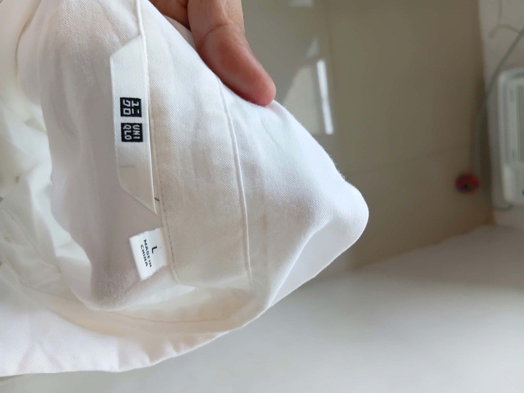Uniqlo White Long Sleeve Button-Down Shirt (Category: Longsleeves) located in Antipolo. Submitted by wisecat.4a7eea (Listing ID 1470077892, Image 3). Description: - Brand: Uniqlo - Item: Classic White Button-Down Shirt - Size: L - Material: 76% rayon, 24% polyester - Features: Long sleeves with cuffs, collar neck, front button closure - Style: Clean minimalist design - Condition: Excellent/Clean - Perfect for: Office wear, interviews, or casual e