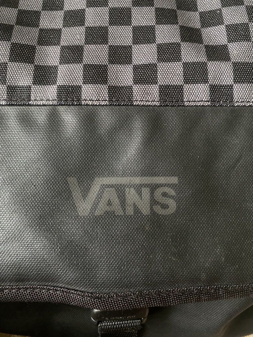 Vans Black and Grey Checkerboard Messenger Bag (Category: Sling Bags) located in Manila. Submitted by diporosmoh43681 (Listing ID 1469975947, Image 2). Description: Vans messenger bag with black and grey checkerboard pattern on the flap. Durable black fabric construction, buckle closure, adjustable shoulder strap with padded section. Zippered pocket on the front flap. Inside features checkered lining, zip pocket, and laptop compartment with velcr