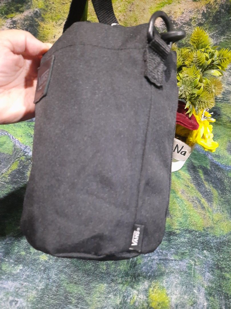 Vans Black Checkered Bucket Crossbody Bag (Category: Cross-body Bags) located in Baguio. Submitted by klayblakeb87803 (Listing ID 1470060219, Image 2). Description: - Authentic Vans bucket bag in solid black canvas - Iconic checkered drawstring top closure - Compact size: 7 inches high with a 6-inch base - Adjustable black shoulder strap with sturdy clips - Vans logo patch on the front and brand tag inside.