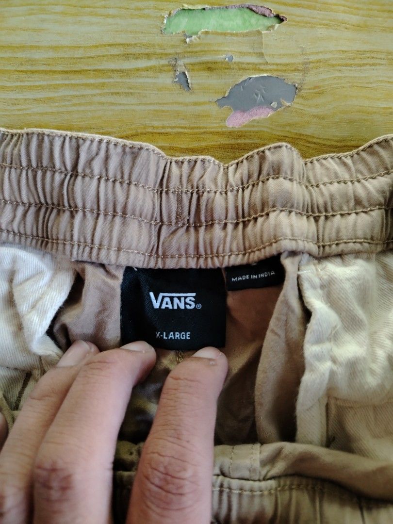 Vans Brown Drawstring Shorts X-Large (Category: Shorts) located in Caloocan City. Submitted by vincefresn21903 (Listing ID 1470016005, Image 3). Description: - Brand: Vans - Color: Brown - Size: XL - Origin: Made in India - Waist: Elastic with adjustable drawstring tie - Details: Back pocket with Vans woven tag, small black Vans tag on left leg hem - Style: Casual, perfect for everyday wear - Condition: Pre-owned with minor wrinkles from storage.