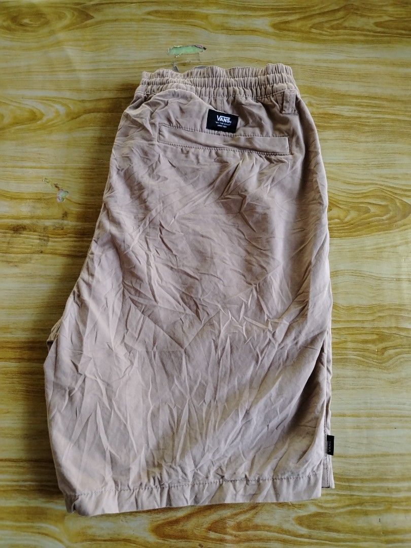 Vans Brown Drawstring Shorts X-Large (Category: Shorts) located in Caloocan City. Submitted by vincefresn21903 (Listing ID 1470016005, Image 2). Description: - Brand: Vans - Color: Brown - Size: XL - Origin: Made in India - Waist: Elastic with adjustable drawstring tie - Details: Back pocket with Vans woven tag, small black Vans tag on left leg hem - Style: Casual, perfect for everyday wear - Condition: Pre-owned with minor wrinkles from storage.