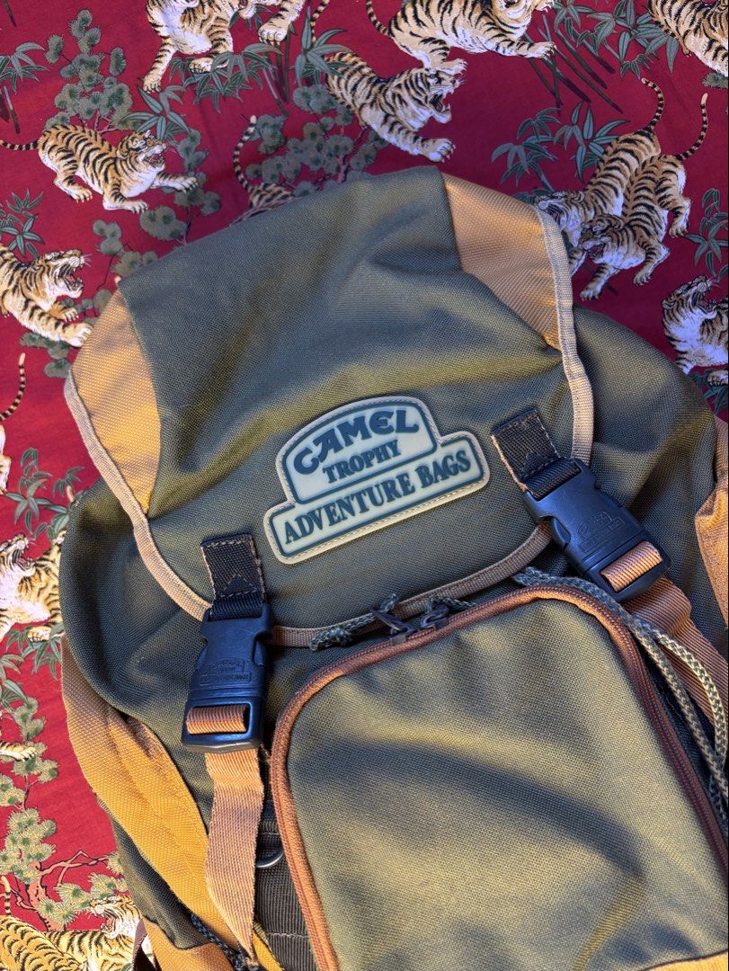 Vintage Camel Trophy Adventure Two-Tone Canvas Backpack (Category: Backpacks) located in Caloocan City. Submitted by ruvendnewborn (Listing ID 1470049531, Image 2). Description: Vintage Camel Trophy Adventure Two-Tone Canvas Backpack Flat Measurements: (IN INCHES) Width: 11” Length: 15” - Excellent vintage condition for its age - Size medium (imho) - Flap top with dual plastic quick-release buckles on the front - “Camel Trophy” branded hardwares 