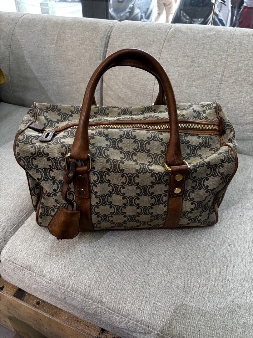 Vintage Celine Paris Canvas Boston Bag (Category: Luxury Bags & Wallets) located in Caloocan City. Submitted by neweagle-424b (Listing ID 1470058029, Image 1). Description: authentic legit Rank B condition scratch sign of used novaliches qc metro manila - Brand: Celine Boston Bag - Material: Brown monogram canvas with leather trim and handles - Interior: Red fabric lining with code S-ST-1019 stamped on the interior tag - Hardware: Gold-tone hardw