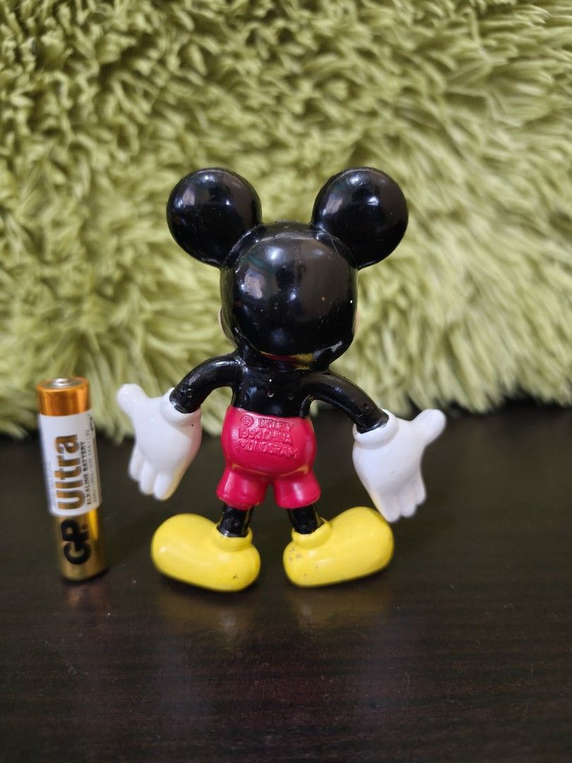 Vintage Disney Mickey Mouse Figurine 1992 (Category: Figurines & Statues) located in La Trinidad. Submitted by charlsensei (Listing ID 1470079108, Image 2). Description: - Vintage 1992 Mickey Mouse plastic figurine in a classic open-arm pose - Authentic Disney stamp on the back of his red shorts - Compact size: stands about as tall as an AAA battery - Condition: Minor paint wear on hands and shoes, consistent with age and gentle play - Perfect ad