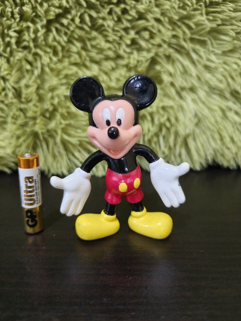 Vintage Disney Mickey Mouse Figurine 1992 (Category: Figurines & Statues) located in La Trinidad. Submitted by charlsensei (Listing ID 1470079108, Image 1). Description: - Vintage 1992 Mickey Mouse plastic figurine in a classic open-arm pose - Authentic Disney stamp on the back of his red shorts - Compact size: stands about as tall as an AAA battery - Condition: Minor paint wear on hands and shoes, consistent with age and gentle play - Perfect ad