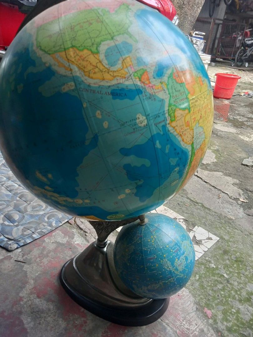 Vintage dual globe world map with stand (Category: Vintage Collectibles) located in Quezon City. Submitted by madelrivera (Listing ID 1469992542, Image 2). Description: - Large world globe with a smaller celestial globe underneath - Detailed map markings clearly showing North and Central America - Stylish metallic finish stand with a sturdy dark base - Solid and steady construction for any desk display - Perfect decorative piece for your study ro