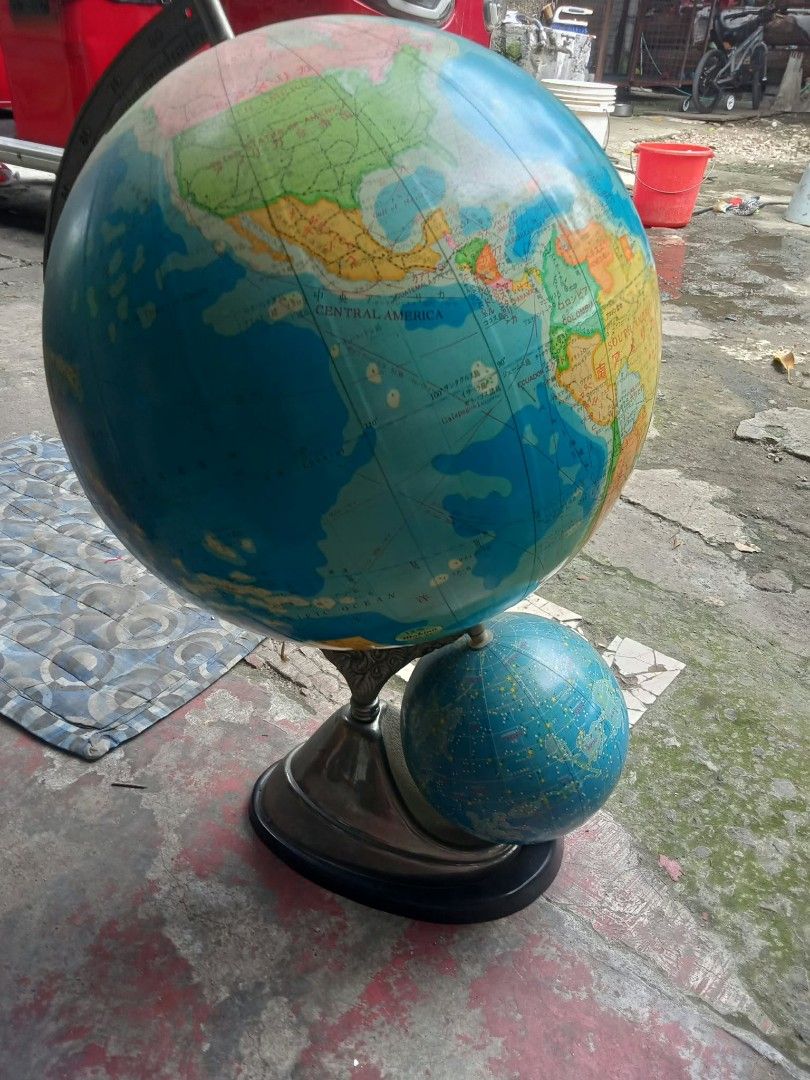 Vintage dual globe world map with stand (Category: Vintage Collectibles) located in Quezon City. Submitted by madelrivera (Listing ID 1469992542, Image 1). Description: - Large world globe with a smaller celestial globe underneath - Detailed map markings clearly showing North and Central America - Stylish metallic finish stand with a sturdy dark base - Solid and steady construction for any desk display - Perfect decorative piece for your study ro