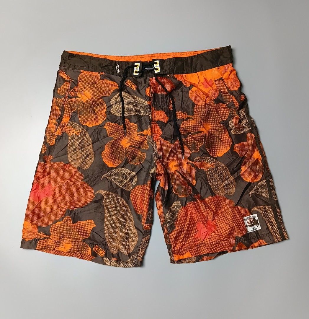vintage Ocean & Earth board shorts (Category: Shorts) located in Manila. Submitted by hustler_777 (Listing ID 1470088250, Image 1). Description: Brand: Ocean and Earth Australia—a well-known, heritage Australian surf hardware and apparel brand established in 1979. Design: An all-over abstract Hawaiian/hibiscus floral print combining a textured orange overlay against a deep dark brown or charcoal base. Hardware & Features: A contrasting dark brown