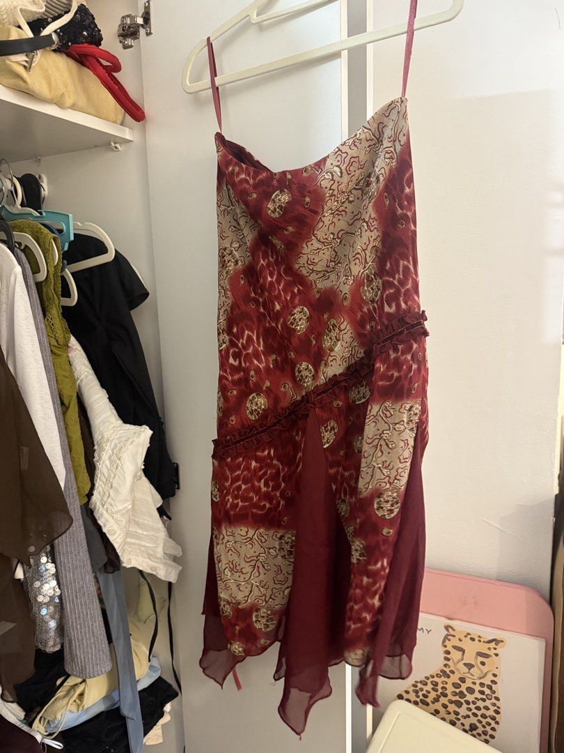 Vintage Red patterned skirt 26-28 (Category: Dresses) located in Quezon City. Submitted by wardrobetreasuresx (Listing ID 1470046361, Image 2). Description: - Deep red and cream abstract print midi dress - Features adjustable/included spaghetti straps - Unique diagonal front ruffle and asymmetrical chiffon hem - Lightweight, semi-sheer fabric - Perfect for parties, dinners, or casual outings - Easy to pair with heels or boots.