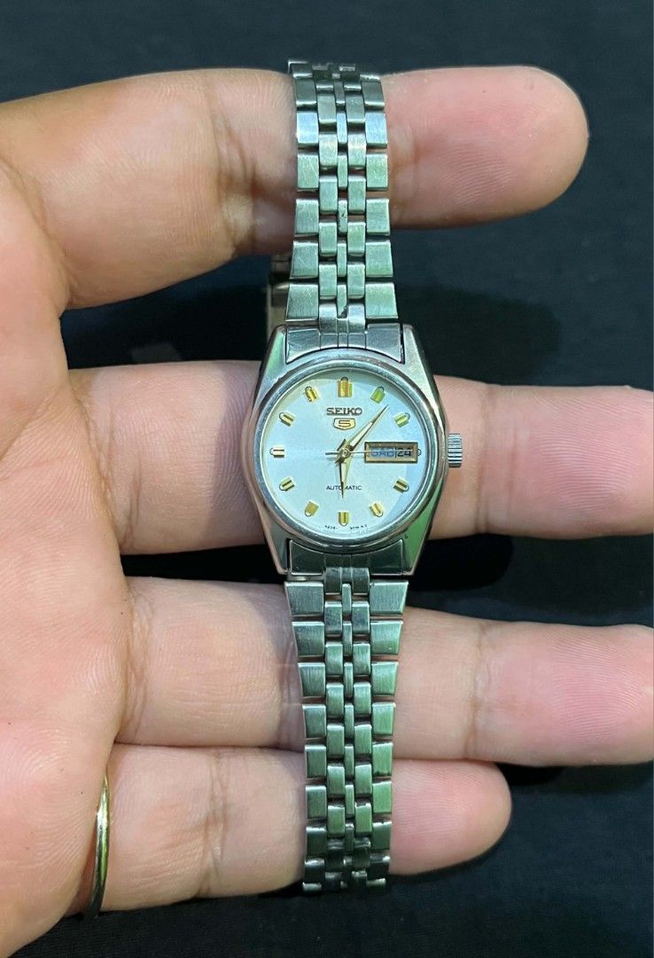 Vintage Seiko 5 Automatic Watch (Category: Men's Watches) located in Cebu City. Submitted by jbok_watches. (Listing ID 1470102696, Image 2). Description: - Brand: Seiko 5 Automatic - Color: Silver-tone with elegant textured dial and gold-tone hands/markers - Features: Convenient day and date window at the 3 o'clock position - Material: Durable stainless steel bracelet with folding clasp - Details: Exhibition case back displaying water-resistance 