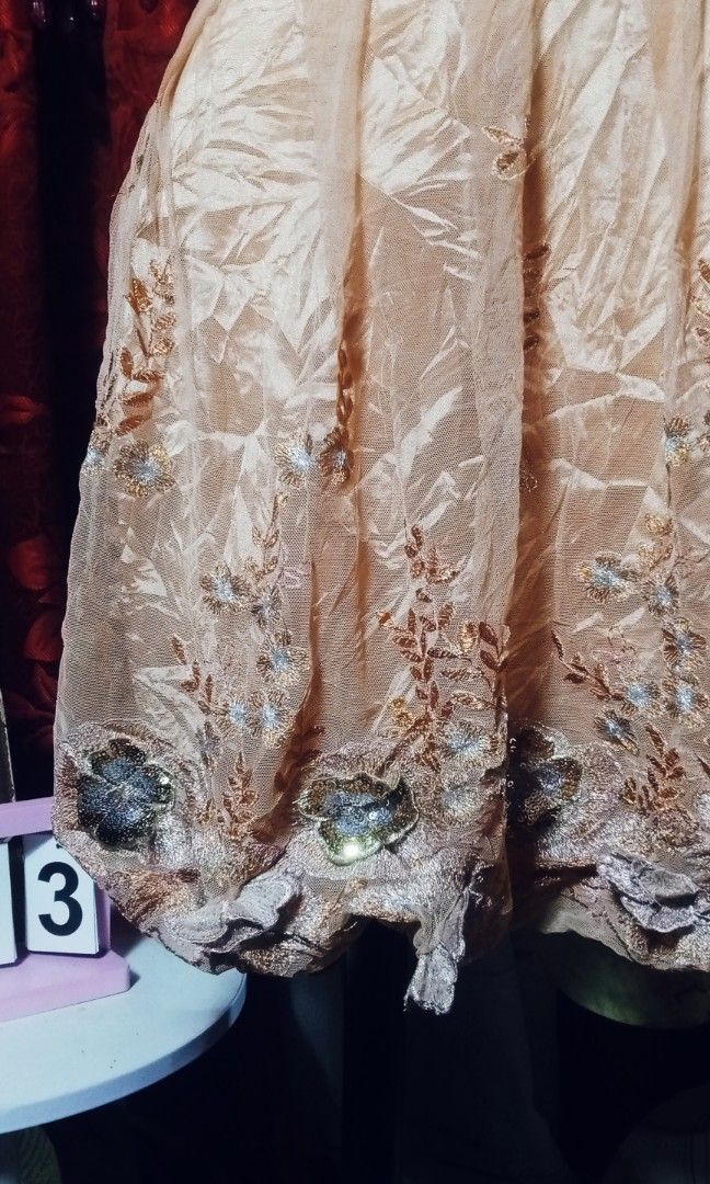 Vintage style dress (Category: Dresses) located in Manila. Submitted by wheneity67thifted (Listing ID 1470136832, Image 3). Description: The image shows a vintage-style peach or blush-pink short cocktail dress featuring an empire waistline, lace yoke, short puffed sleeves, and decorative floral embroidery along the hem and belt area.
