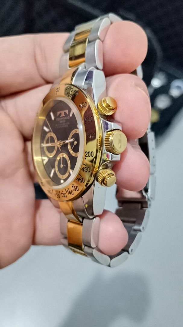 Vintage Technos Chronograph Watch Two-tone (Category: Men's Watches) located in Malolos. Submitted by chrono_revival (Listing ID 1470050176, Image 2). Description: PLEASE READ THE FULL POST BEFORE SENDING ANY INQUIRIES. SERIOUS OFFERS ONLY PLEASE. ********** Authentic Technos TGM-615 - Men’s Swiss Watch Diver’s Chronograph - Black dial with gold sub-dials - Non-rotating gold bezel - Screw-down crown - Original signature two-tone bracelet - Case s