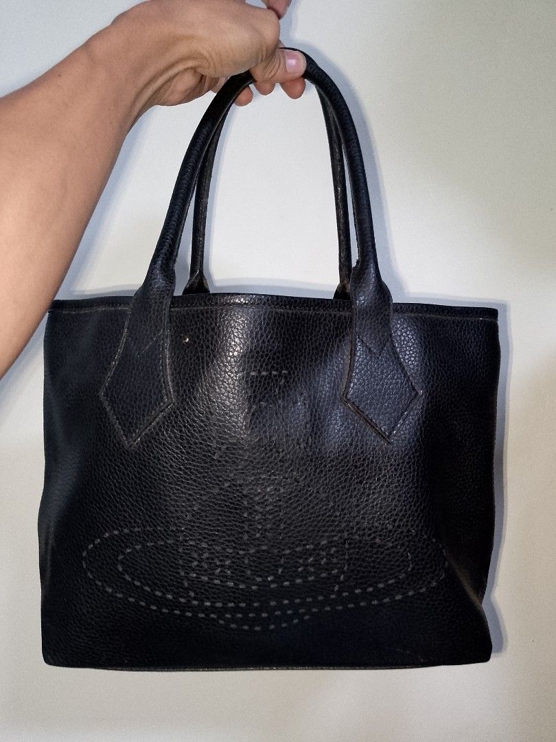 Vivienne Westwood Black Leather Bag (Category: Luxury Bags & Wallets) located in Manila. Submitted by mjthrifted_second (Listing ID 1469975704, Image 1). Description: - Brand: Vivienne Westwood London - Material: Genuine black pebble leather, Made in Italy - Hardware: Gold tone with metal logo plaque - Closure: Secure magnetic snap - Interior: Patterned satin lining with a zip compartment - Design: Structured bottom with sturdy twin grab handles.