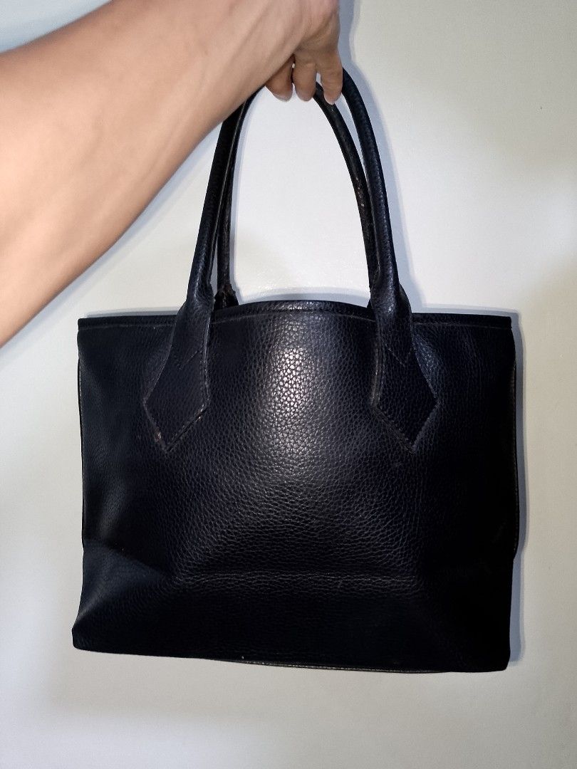 Vivienne Westwood Black Leather Bag (Category: Luxury Bags & Wallets) located in Manila. Submitted by mjthrifted_second (Listing ID 1469975704, Image 2). Description: - Brand: Vivienne Westwood London - Material: Genuine black pebble leather, Made in Italy - Hardware: Gold tone with metal logo plaque - Closure: Secure magnetic snap - Interior: Patterned satin lining with a zip compartment - Design: Structured bottom with sturdy twin grab handles.