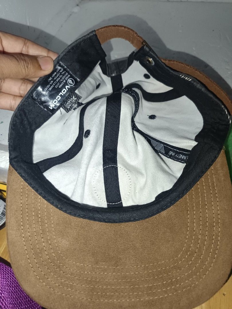 Volcom Cap Gray Brown Triangle Pattern (Category: Cap & Hats) located in Kuala Terengganu. Submitted by nazurah92 (Listing ID 1470023146, Image 3). Description: - Brand: Volcom - Style: Snapback cap with flat brim - Color/Design: Dark gray crown with white geometric triangle pattern and brown faux suede brim - Details: Round leather Volcom patch on front center, black adjustable strap with metal buckle - Material: 60% cotton, 40% polyester blend 