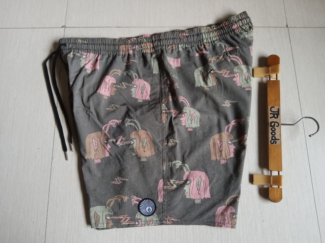 Volcom Graphic Print Drawstring Shorts Olive Green (Category: Activewear) located in Tanay. Submitted by jrgoods (Listing ID 1469997150, Image 1). Description: Volcom Xxl to XL above the knee waistline 36-40 Length 18 Good as new condition 550+ship Tanay Rizal location Shipping Nationwide - Color: Olive green with quirky psychic head and lightning bolt graphics - Waistband: Elastic with adjustable black drawstring cords - Pockets & Details: Back 
