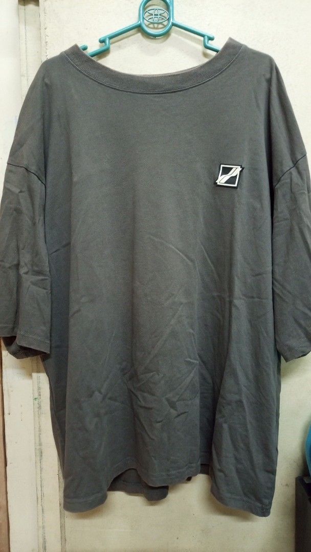 WE11DONE Grey Oversized T-Shirt Size S (Category: Tshirts & Polo Shirts ) located in Manila. Submitted by rizu09 (Listing ID 1470040242, Image 1). Description: - Brand: WE11DONE - Color: Grey - Size: S (Oversized fit) - Material: 100% Cotton (Made in Korea) - Design: Small square logo patch on chest with a large, colorful graphic print across the back - Style: Streetwear, relaxed fit.