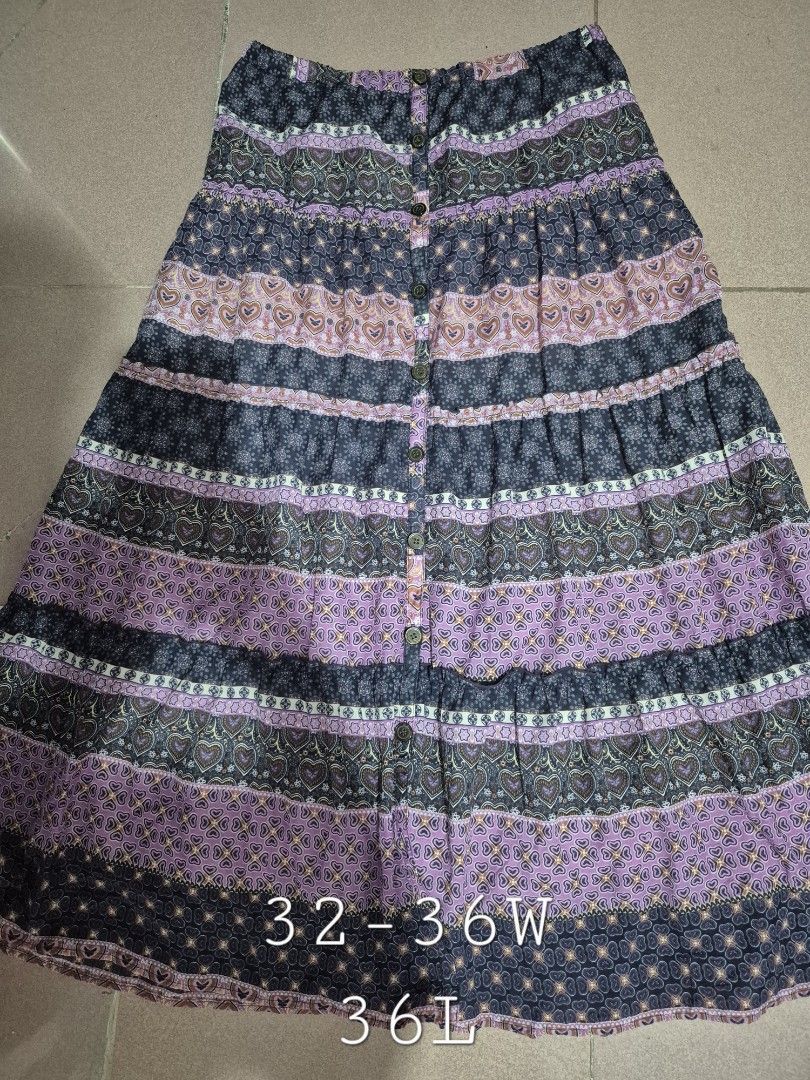 Whimsy Purple Boho Hearts Tiered Ruffle Buttoned Maxi Skirt (Category: Skirts) located in Calamba. Submitted by bb.lace (Listing ID 1469973831, Image 1). Description: -functional buttons, can be worn fully buttoned or open and with inner lining -printed design with tiered mini ruffles -twirly when worn.