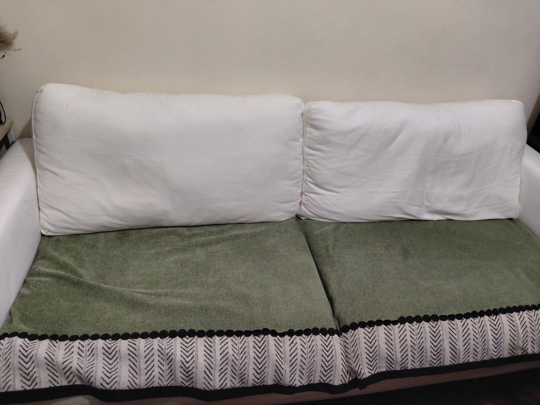 White 2-seater sofa with green patterned seat covers (Category: Sofas) located in Manila. Submitted by boldtree-0643 (Listing ID 1470120495, Image 1). Description: - Type: Two-seater sofa for living room or lounge - Frame: Clean white frame with oversized white back cushions - Seat Covers: Green velvet-style with black pom-pom trim and black-and-white chevron pattern - Maintenance: Removable covers for easy washing - Condition: Excellent and read