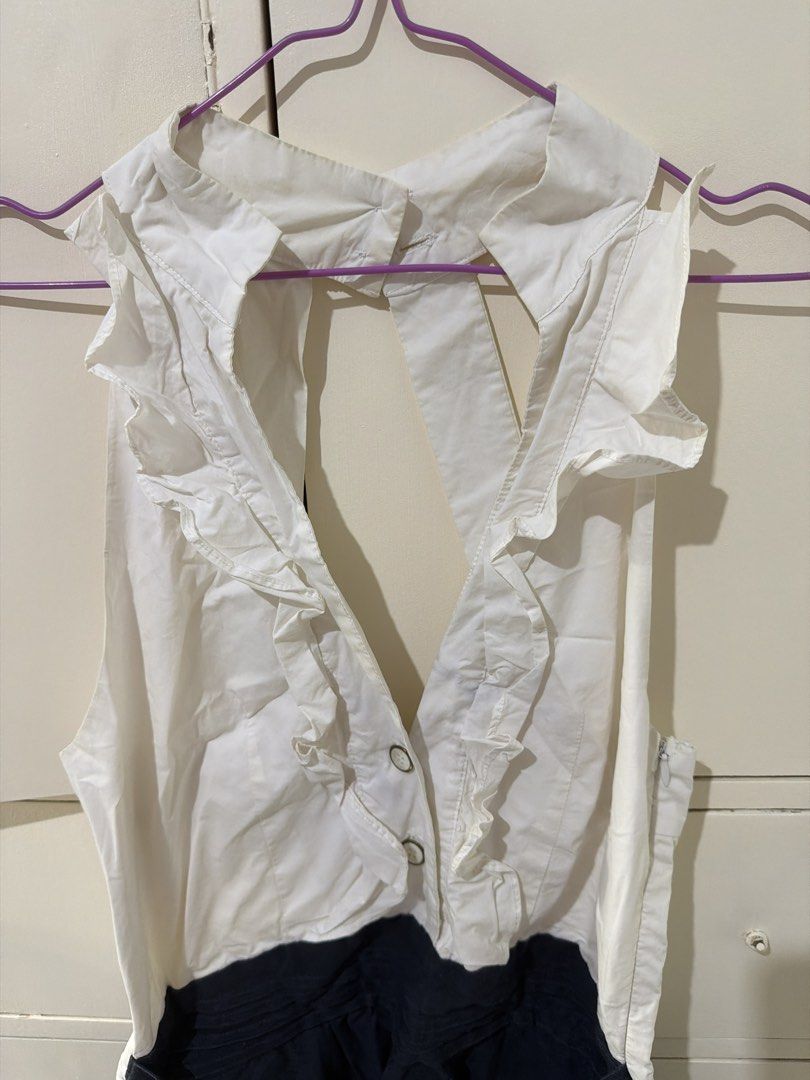 White and Navy Blue Ruffle Halter Romper (Category: Rompers) located in Rizal. Submitted by kyliemaine (Listing ID 1470023469, Image 2). Description: - Two-tone design: white sleeveless halter top and dark blue shorts - Halter neck with back button closure and charming front ruffle trim - Trendy open back design - Shorts feature a matching tie belt at the waist and cuffed hems - Side zipper for easy changing - Ideal for warm weather days or casua