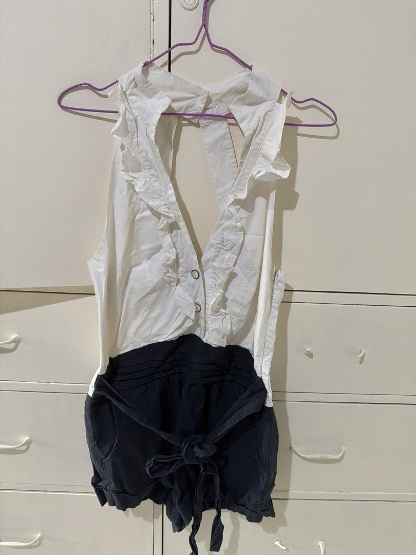 White and Navy Blue Ruffle Halter Romper (Category: Rompers) located in Rizal. Submitted by kyliemaine (Listing ID 1470023469, Image 1). Description: - Two-tone design: white sleeveless halter top and dark blue shorts - Halter neck with back button closure and charming front ruffle trim - Trendy open back design - Shorts feature a matching tie belt at the waist and cuffed hems - Side zipper for easy changing - Ideal for warm weather days or casua
