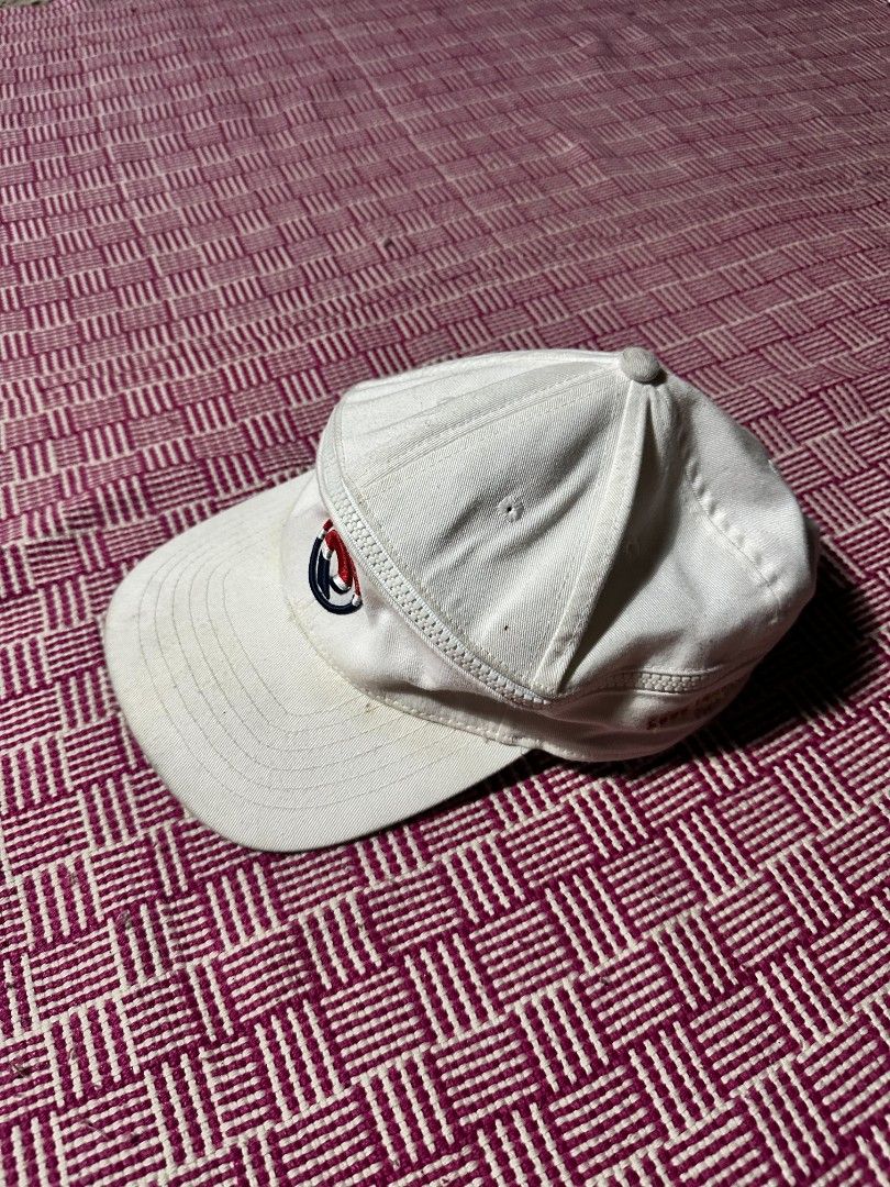 White baseball cap with embroidered logo (Category: Caps & Hats) located in Manila. Submitted by wardrobeph.com (Listing ID 1470124241, Image 1). Description: - Color: Clean white - Design: Structured crown with curved brim and unique side zipper detail - Branding: Small embroidered logo on the front - Fit: Adjustable strap closure for a custom fit - Condition: Brand new, fresh, and ready to wear.