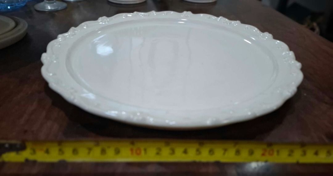 White Decorative Rim Serving Plate (Category: Dinnerware & Cutlery) located in Pasig City. Submitted by dripcounty (Listing ID 1470025922, Image 1). Description: White Decorative Rim Serving Plate ₱150 Bought in the Philippines Condition: Good / preloved White round serving plate with decorative scalloped rim, smaller than the separately listed large platter. See tape photo for approximate size. Actual item shown in photos. Delivery fee shouldere