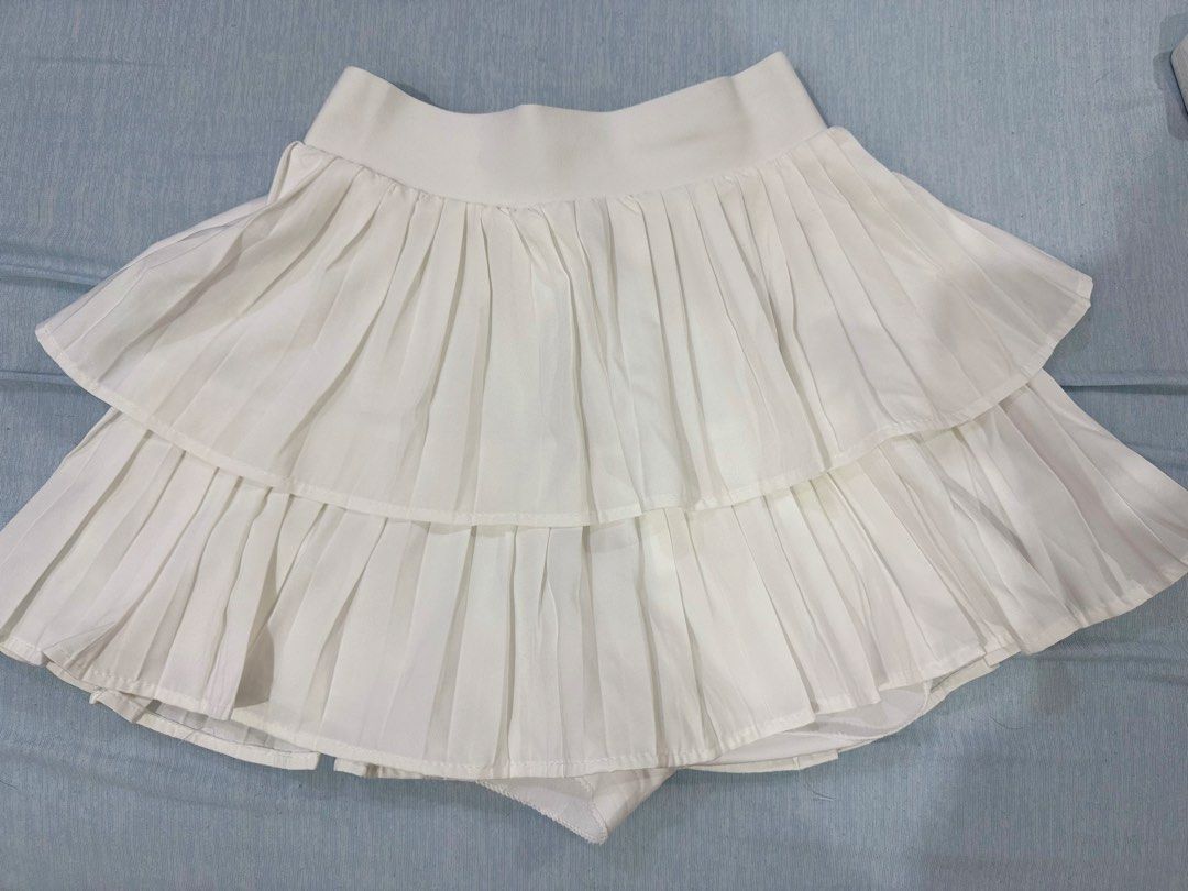 White Double-Layer Pleated Skort (Category: Skirts) located in Manila. Submitted by buymiclothes.47 (Listing ID 1470092691, Image 1). Description: Cream Double-Layer Pleated Skort | ₱100 Cute cream/off-white pleated mini skort with a double-layer design and built-in shorts! * Very stretchable — fits up to 30waist * Color: Cream / Off-white * Waist: Approx. 11.5–12 inches (laid flat) * Elastic waistband * Built-in shorts underneath * Condition: Pr