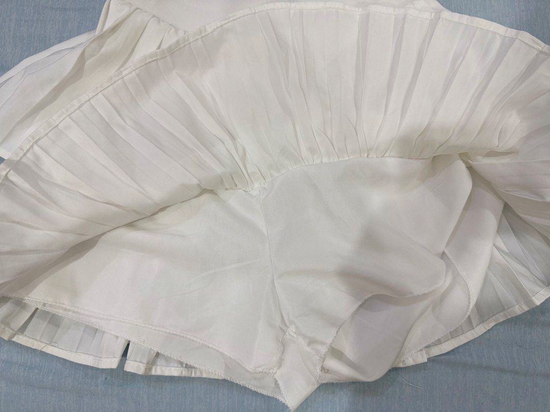 White Double-Layer Pleated Skort (Category: Skirts) located in Manila. Submitted by buymiclothes.47 (Listing ID 1470092691, Image 2). Description: Cream Double-Layer Pleated Skort | ₱100 Cute cream/off-white pleated mini skort with a double-layer design and built-in shorts! * Very stretchable — fits up to 30waist * Color: Cream / Off-white * Waist: Approx. 11.5–12 inches (laid flat) * Elastic waistband * Built-in shorts underneath * Condition: Pr