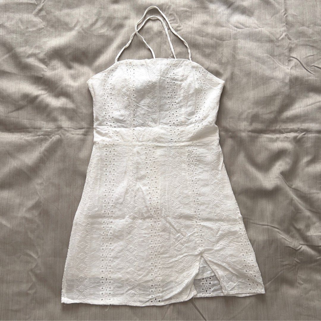White Eyelet Halter Mini Dress with Front Slit (Category: Dresses) located in Pasig City. Submitted by jenscloset86 (Listing ID 1469954754, Image 1). Description: Brand: ZAFUL Size: Small • Used 2X only as beach outfit. • No damage, no flaws Measurement: Waist: 25” Length: 29” Bust: 32-34”.