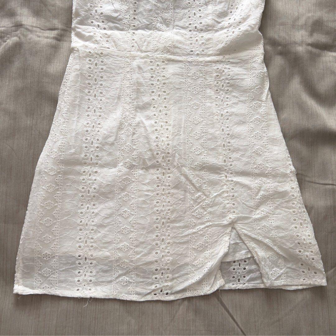 White Eyelet Halter Mini Dress with Front Slit (Category: Dresses) located in Pasig City. Submitted by jenscloset86 (Listing ID 1469954754, Image 2). Description: Brand: ZAFUL Size: Small • Used 2X only as beach outfit. • No damage, no flaws Measurement: Waist: 25” Length: 29” Bust: 32-34”.