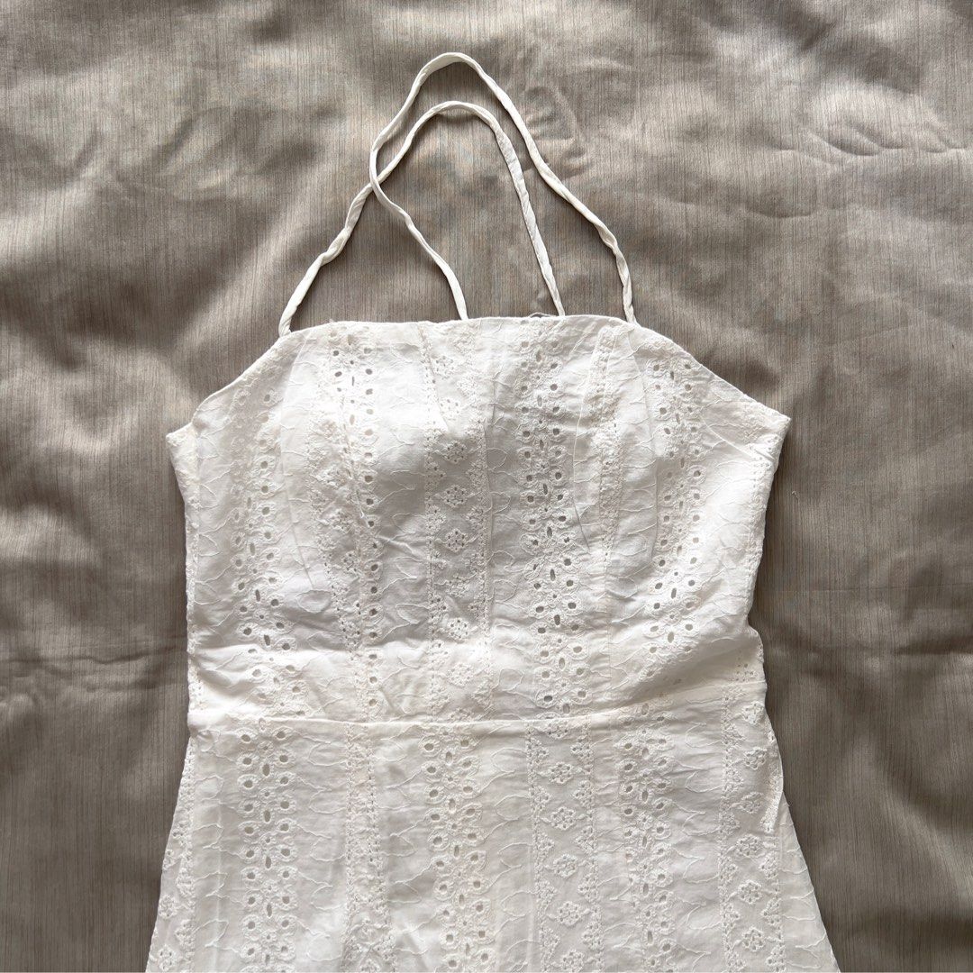 White Eyelet Halter Mini Dress with Front Slit (Category: Dresses) located in Pasig City. Submitted by jenscloset86 (Listing ID 1469954754, Image 3). Description: Brand: ZAFUL Size: Small • Used 2X only as beach outfit. • No damage, no flaws Measurement: Waist: 25” Length: 29” Bust: 32-34”.