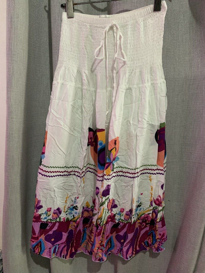 White floral smocked skirt with drawstring (Category: Skirts) located in Manila. Submitted by keiv.studio (Listing ID 1470003746, Image 1). Description: can fit s-m - Style: White midi skirt with a vibrant floral and abstract print hem - Fabric: Lightweight and breathable, ideal for hot weather and vacations - Length: Mid-calf - Condition: Excellent (Ready to ship!).