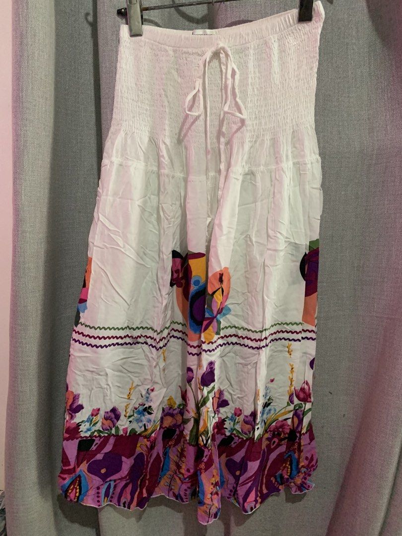 White floral smocked skirt with drawstring (Category: Skirts) located in Manila. Submitted by keiv.studio (Listing ID 1470003746, Image 2). Description: can fit s-m - Style: White midi skirt with a vibrant floral and abstract print hem - Fabric: Lightweight and breathable, ideal for hot weather and vacations - Length: Mid-calf - Condition: Excellent (Ready to ship!).