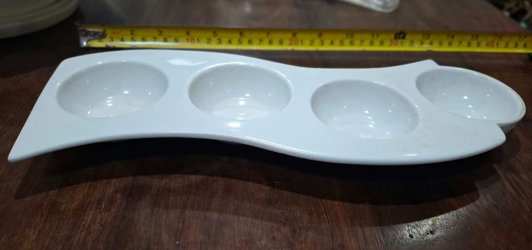 White Four Section Condiment Tray (Category: Dinnerware & Cutlery) located in Pasig City. Submitted by dripcounty (Listing ID 1470026181, Image 1). Description: White Four Section Condiment Tray ₱150 Bought in the Philippines Condition: Good / preloved White serving tray with four round recessed compartments. Small surface marks visible. Actual item shown in photos. Delivery fee shouldered by buyer (Lalamove / other courier). Item price excludes 
