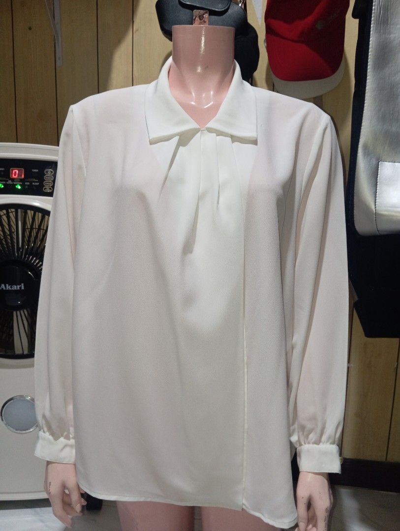 White Long Sleeve Collared Blouse (Category: Longsleeves) located in Cebu City. Submitted by smnthdanielle (Listing ID 1470128410, Image 2). Description: - Color: White - Style: Long sleeve blouse with a pointed collar and buttoned cuffs - Fit: Relaxed fit through the body for maximum comfort - Details: Smooth fabric with elegant pleated front placket - Versatility: Easily pairs with skirts or trousers for work or casual outings - Condition: Bran