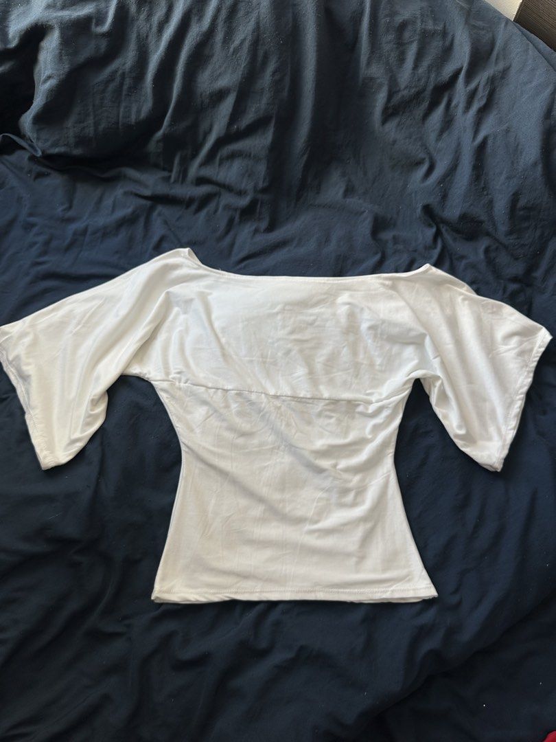 White Off-Shoulder Top Wide Sleeves (Category: Blouses) located in Quezon City. Submitted by valeriorac74670 (Listing ID 1470044909, Image 2). Description: - Color: White - Style: Off-shoulder with wide sleeves and a fitted body - Neckline: Scoop neckline that flatters the collarbone - Comfort: Lightweight fabric for all-day wear - Versatility: Clean look, easy to pair with jeans or skirts.