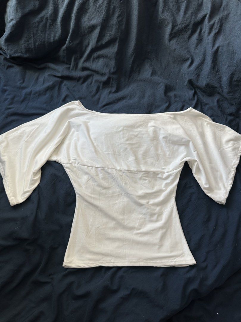 White Off-Shoulder Top Wide Sleeves (Category: Blouses) located in Quezon City. Submitted by valeriorac74670 (Listing ID 1470044909, Image 1). Description: - Color: White - Style: Off-shoulder with wide sleeves and a fitted body - Neckline: Scoop neckline that flatters the collarbone - Comfort: Lightweight fabric for all-day wear - Versatility: Clean look, easy to pair with jeans or skirts.