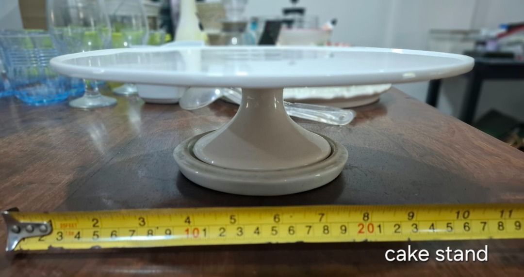 White Pedestal Cake Stand (Category: Bakeware) located in Pasig City. Submitted by dripcounty (Listing ID 1470026356, Image 1). Description: White Pedestal Cake Stand ₱250 Bought in the Philippines Condition: Good / preloved White round pedestal cake stand. Sold as pictured, without cover. See tape photo for approximate size. Actual item shown in photos. Delivery fee shouldered by buyer (Lalamove / other courier). Item price excludes delivery. Pa