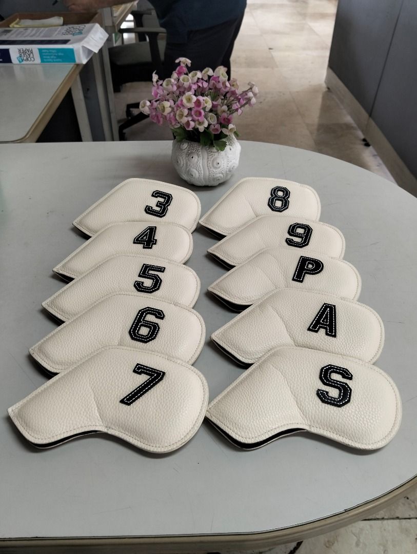 White PU Leather Golf Iron Head Covers Set 3-9, P, A, S (Category: Golf) located in Binan City. Submitted by croti_by_juliechi (Listing ID 1470138509, Image 1). Description: - Complete set of 10 golf iron covers (3, 4, 5, 6, 7, 8, 9, P, A, S) - Premium white synthetic leather with a stylish textured pebble finish - Bold black embroidered numbers and lettering for easy club identification - Slanted shape designed to fit standard iron clubs snugly 